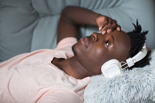 Man lying on sofa tired after 8 hours of sleep